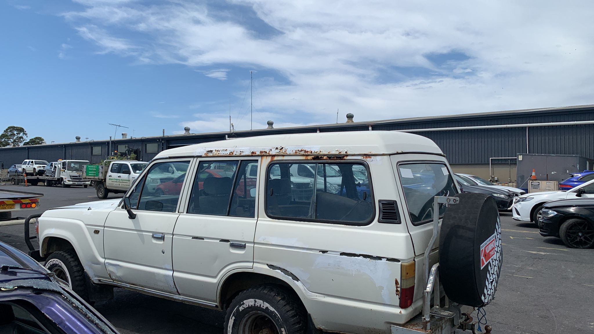 Sell My Scrap Car Blind Bight VIC 1 White four-wheel drive parked among vehicles