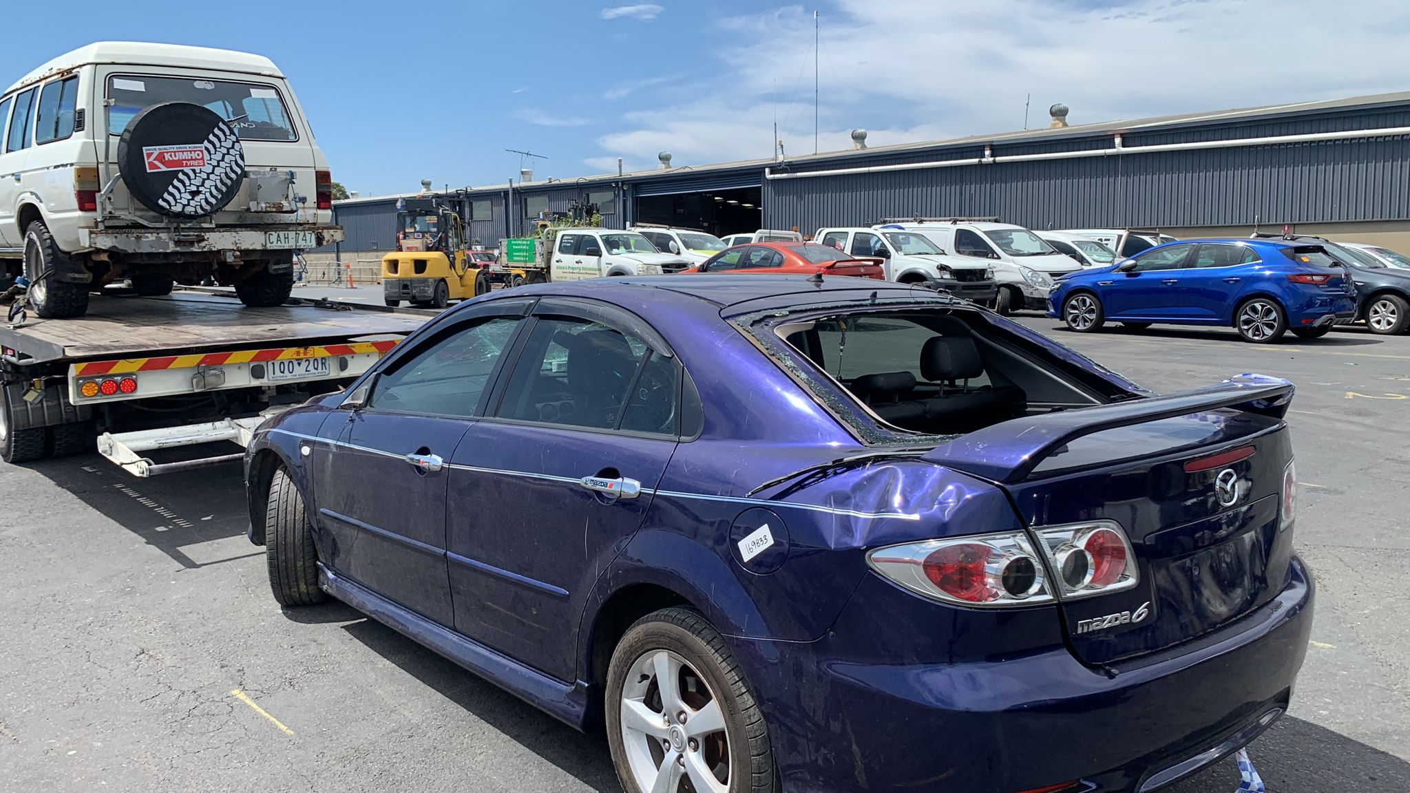 Sell My Scrap Car Windsor VIC 1 Dark sedan with rear damage in a vehicle yard