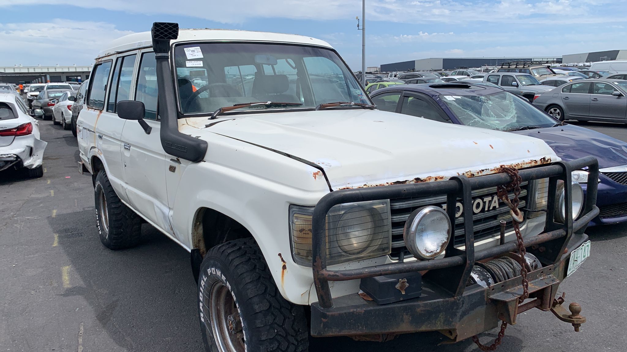 White utility vehicle in a vehicle yard