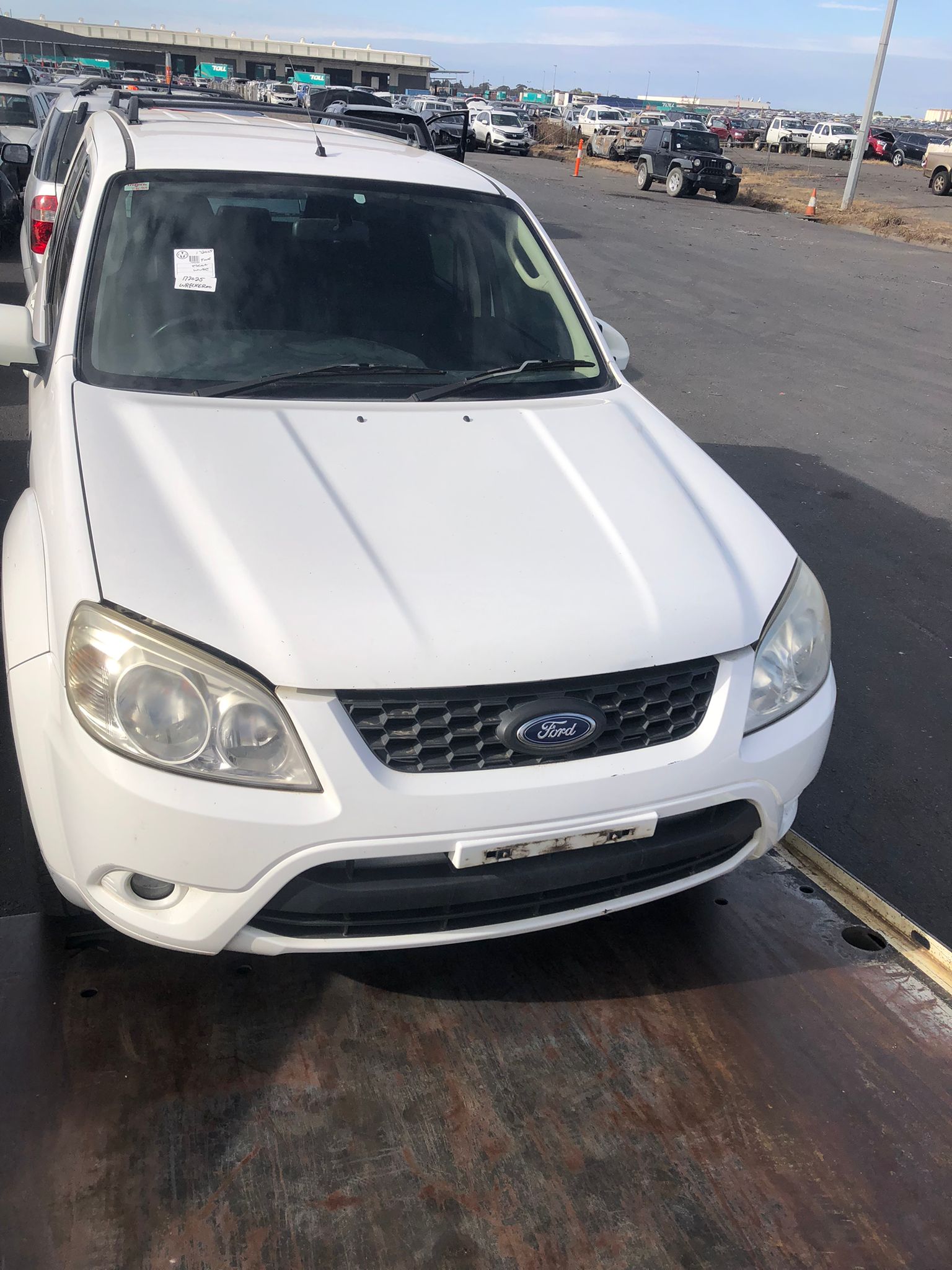 Sell My Scrap Car Plumpton VIC 1 Light-coloured hatchback in a vehicle yard