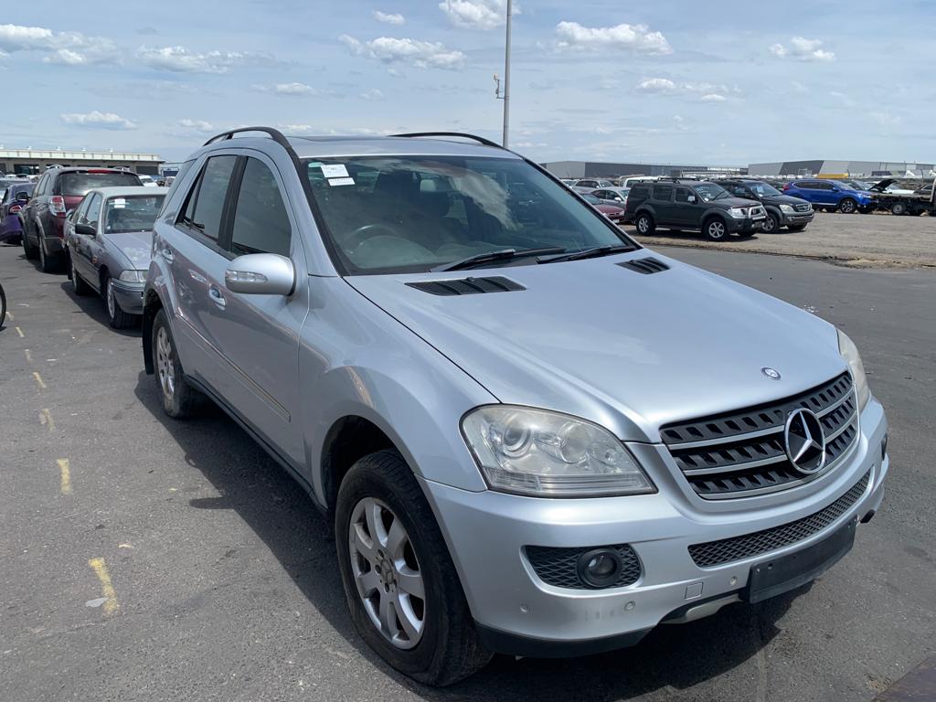 Silver four-wheel drive parked among vehicles