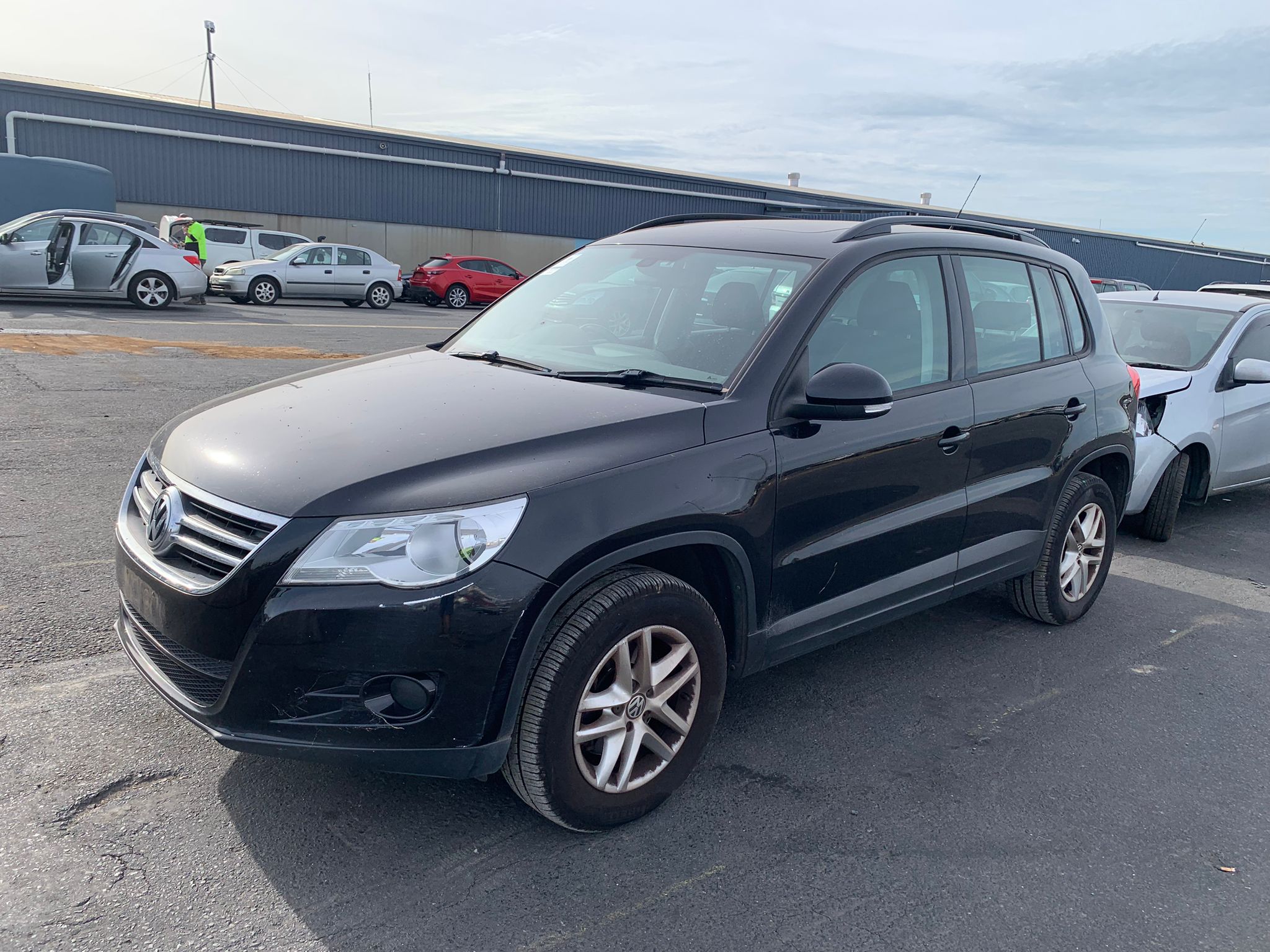 Dark SUV parked in a vehicle yard