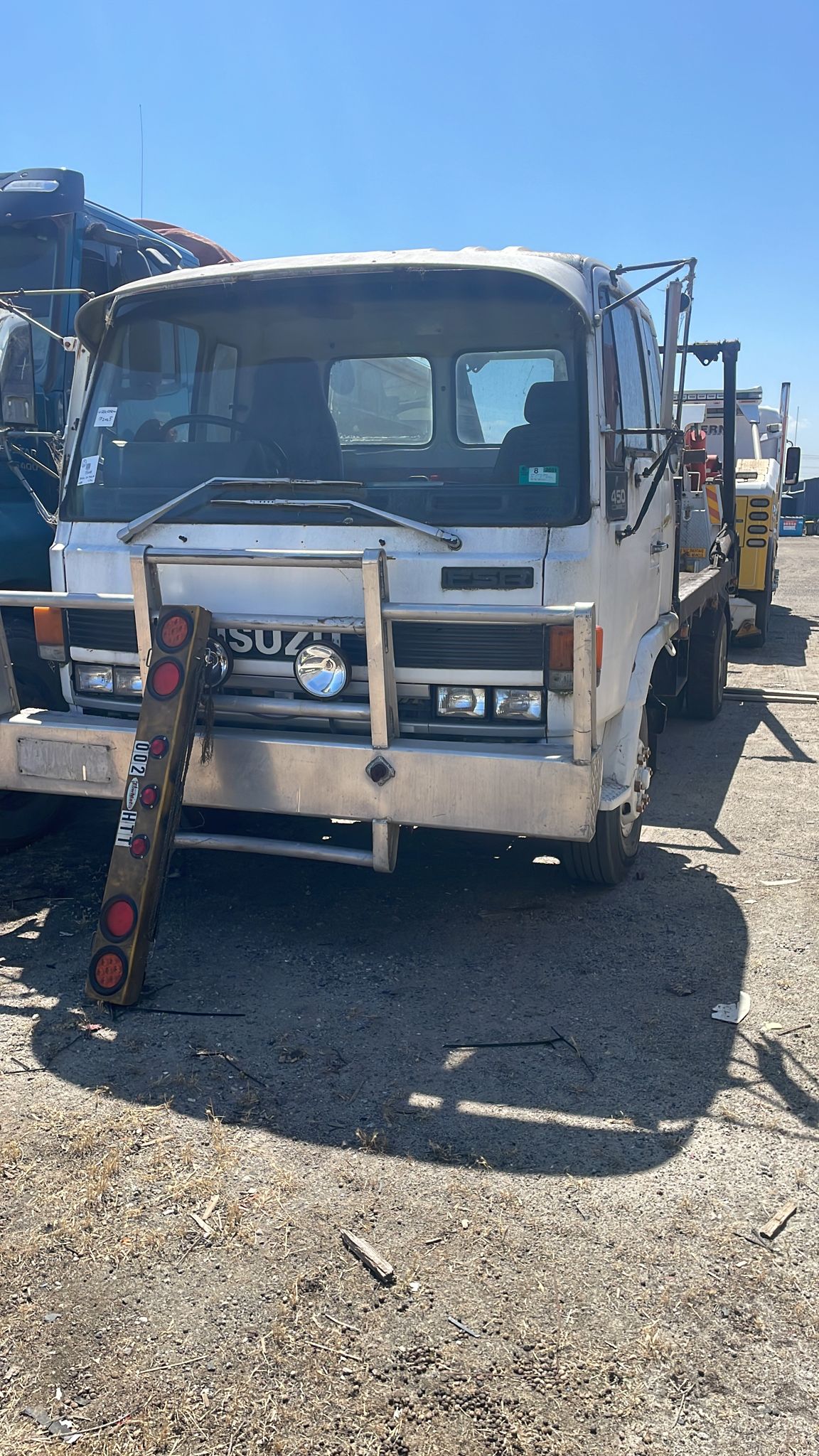 Truck photographed from the front in a vehicle yard