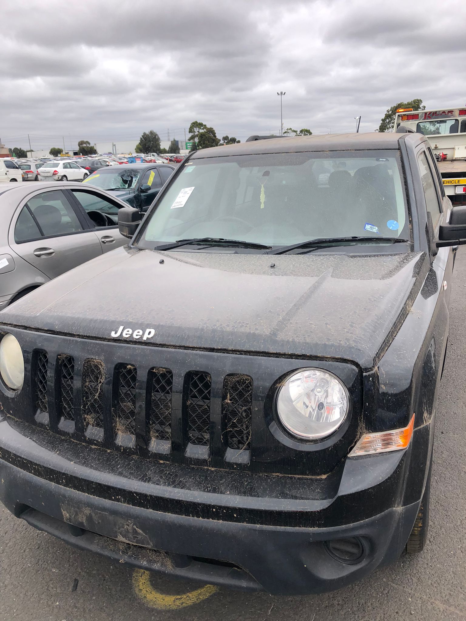 Dark four-wheel drive in a vehicle yard