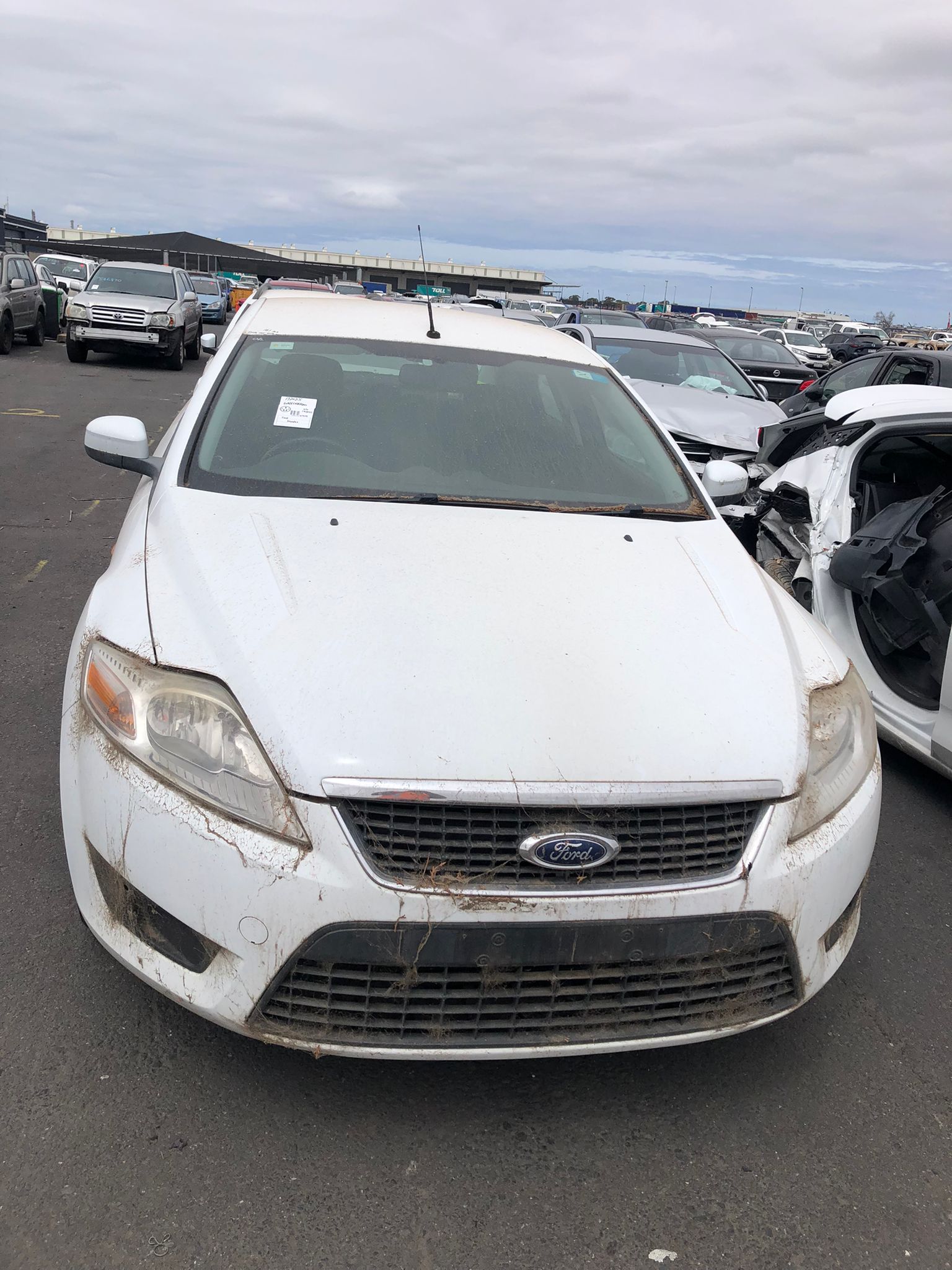 Sell My Scrap Car Aspendale VIC 1 White sedan in a vehicle yard