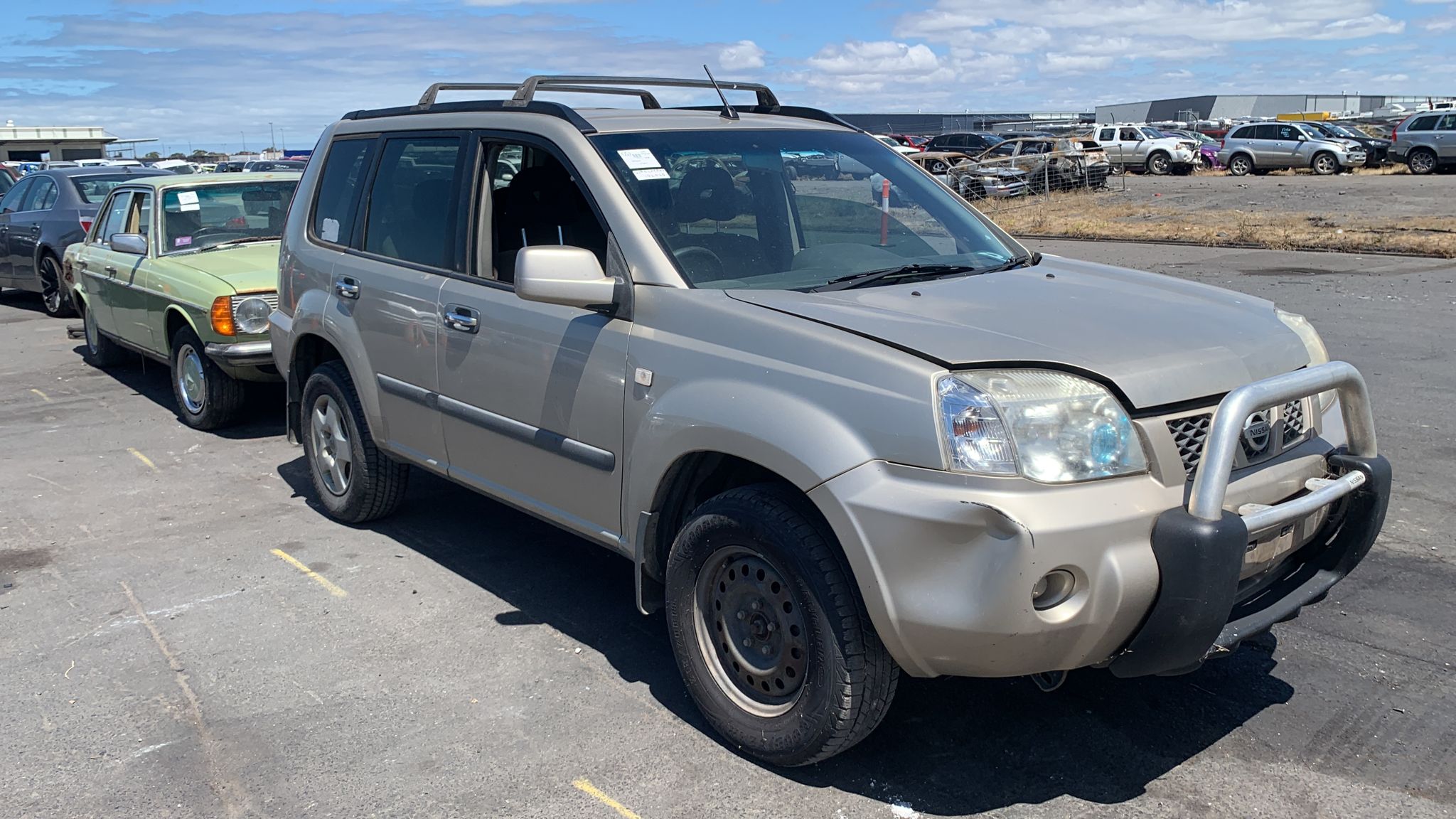 Silver four-wheel drive parked among vehicles