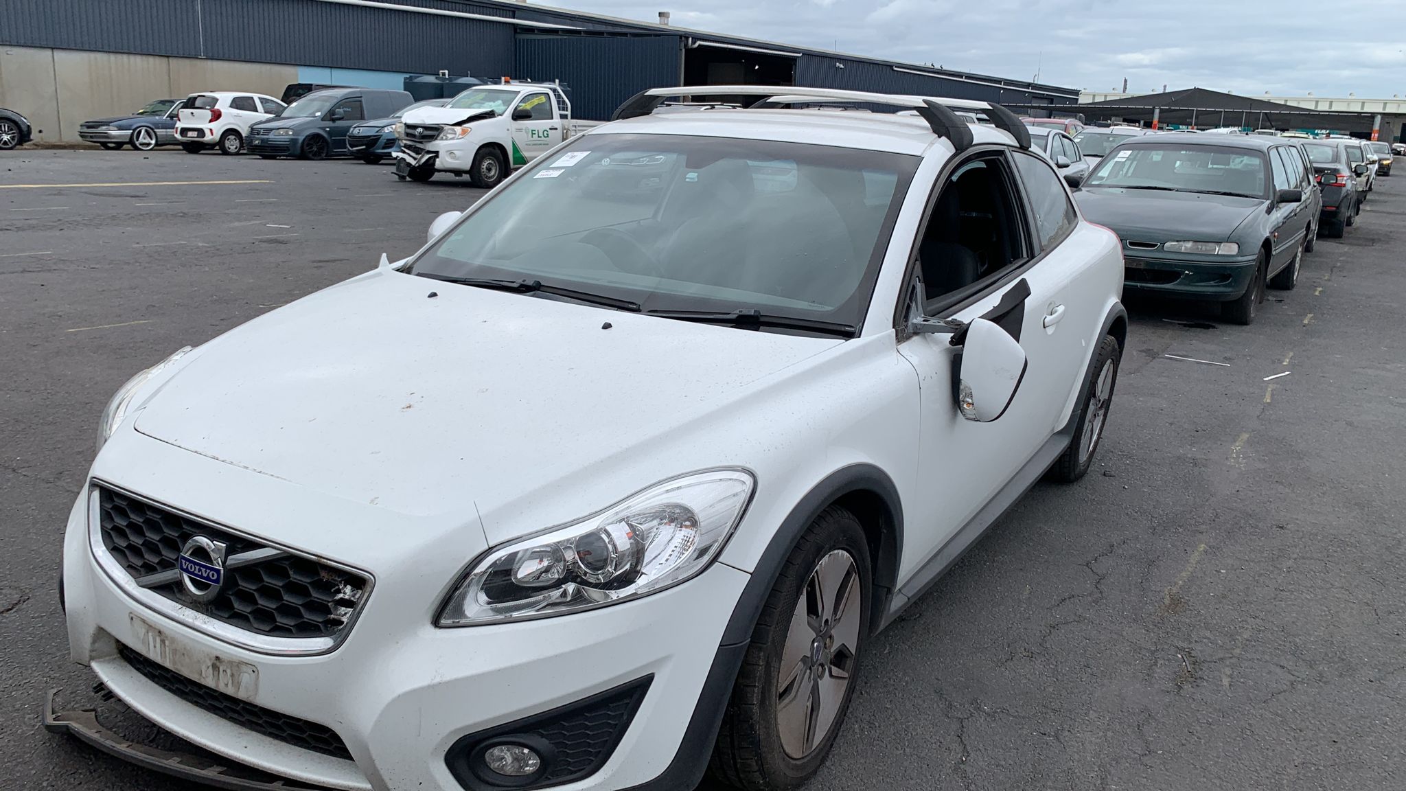 White wagon parked among vehicles