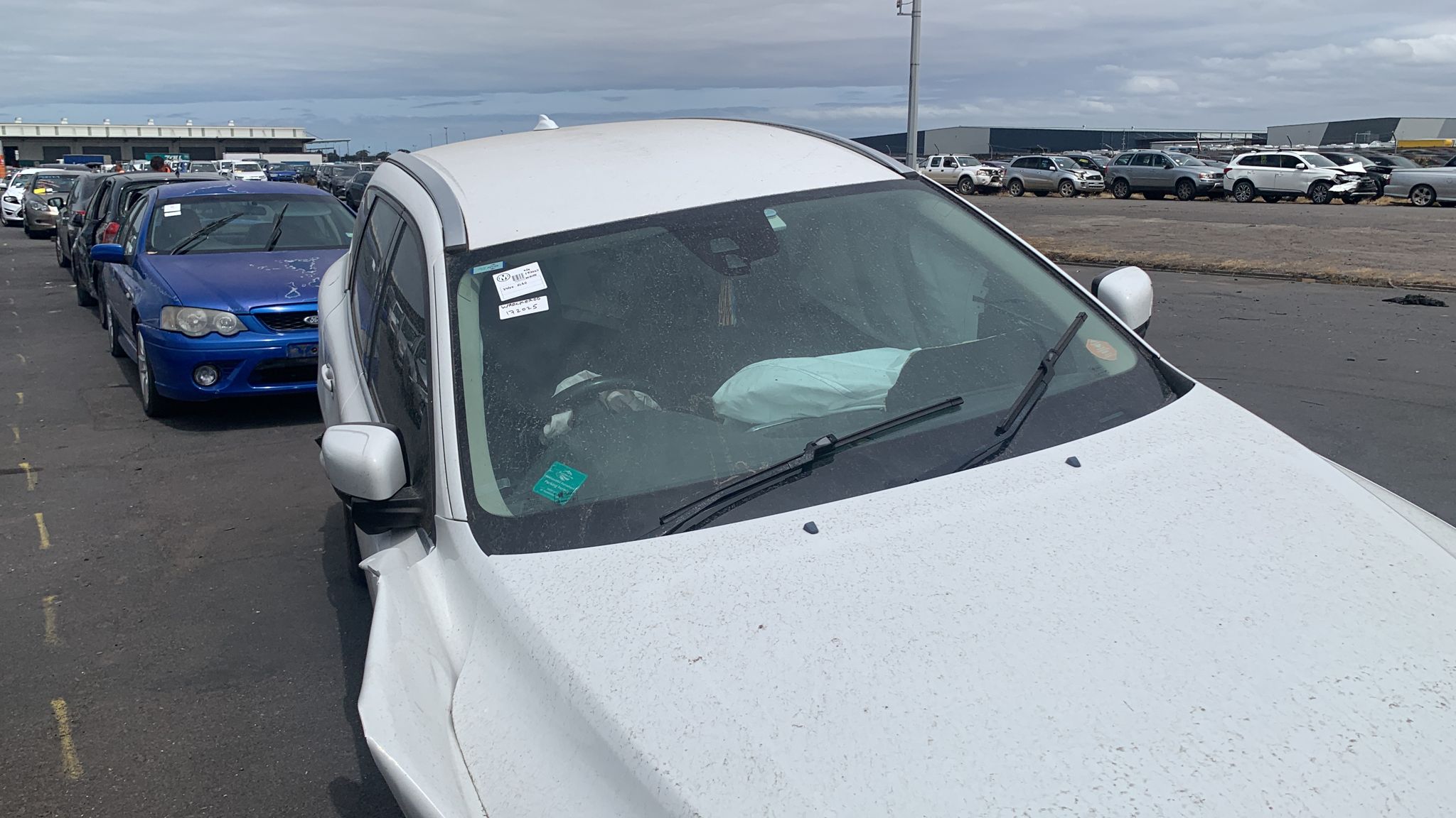Silver wagon in a vehicle yard