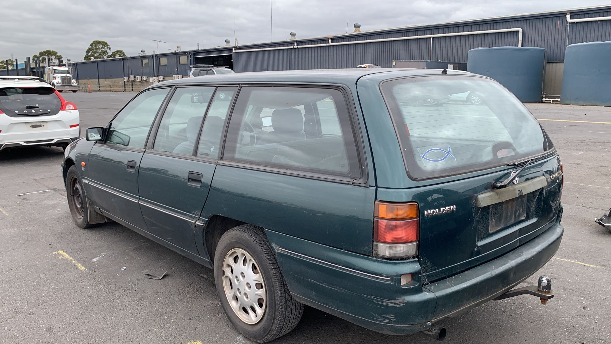 Dark station wagon in a vehicle yard